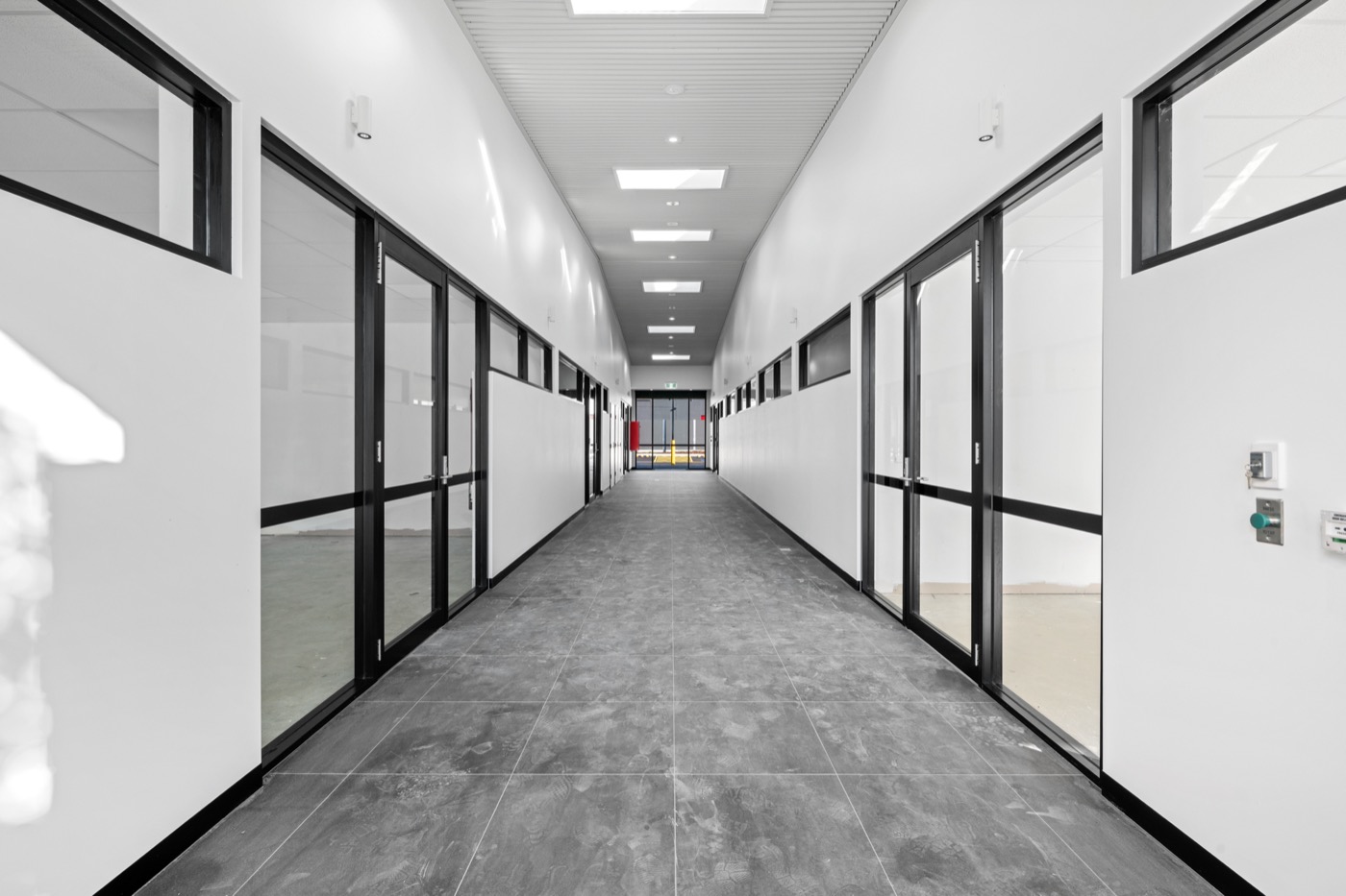 Central tenant corridor with glass-fronted suites